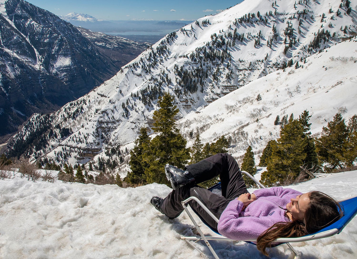 Woman sitting in a chair overlooking Utah Valley at Sundance Mountain Resort.