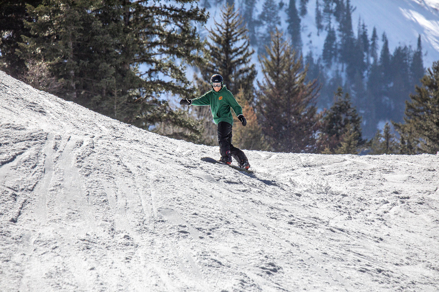 Snowboarder on a snowy slope at Sundance Mountain Resort in Utah.